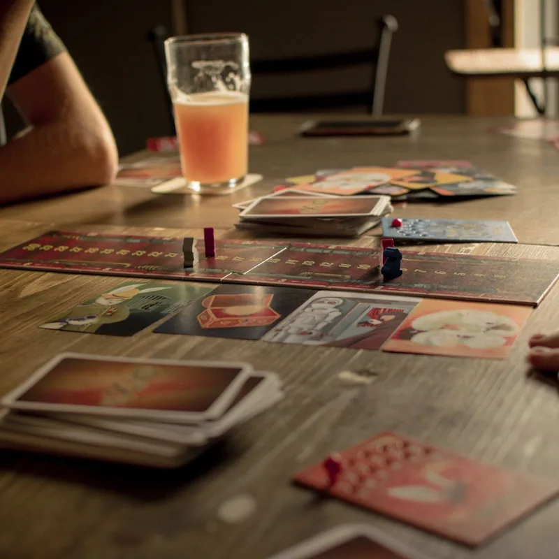 People playing a board game around a café table